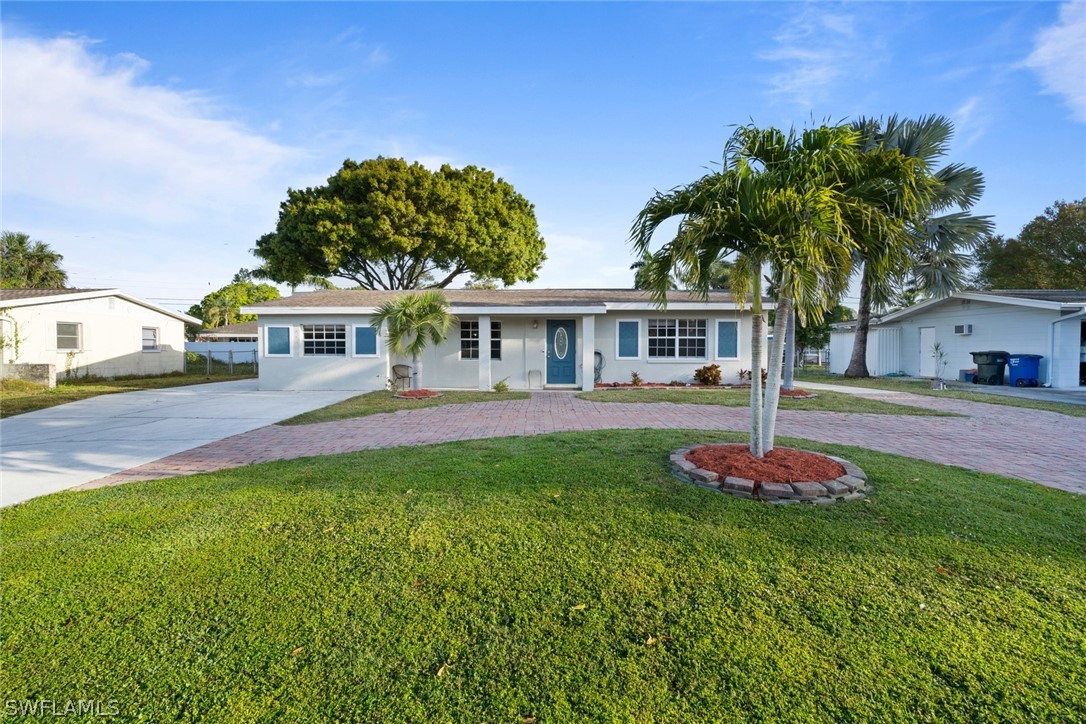 1447 Collins Road Fort Myers, FL 33919 - Photo 4 of 34 a front view of a house with a yard