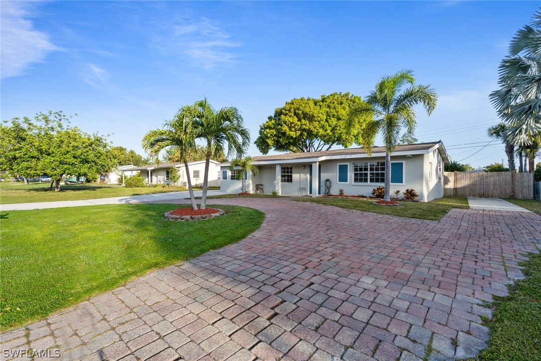 1447 Collins Road Fort Myers, FL 33919 - Photo 5 of 34 a front view of a house with a garden