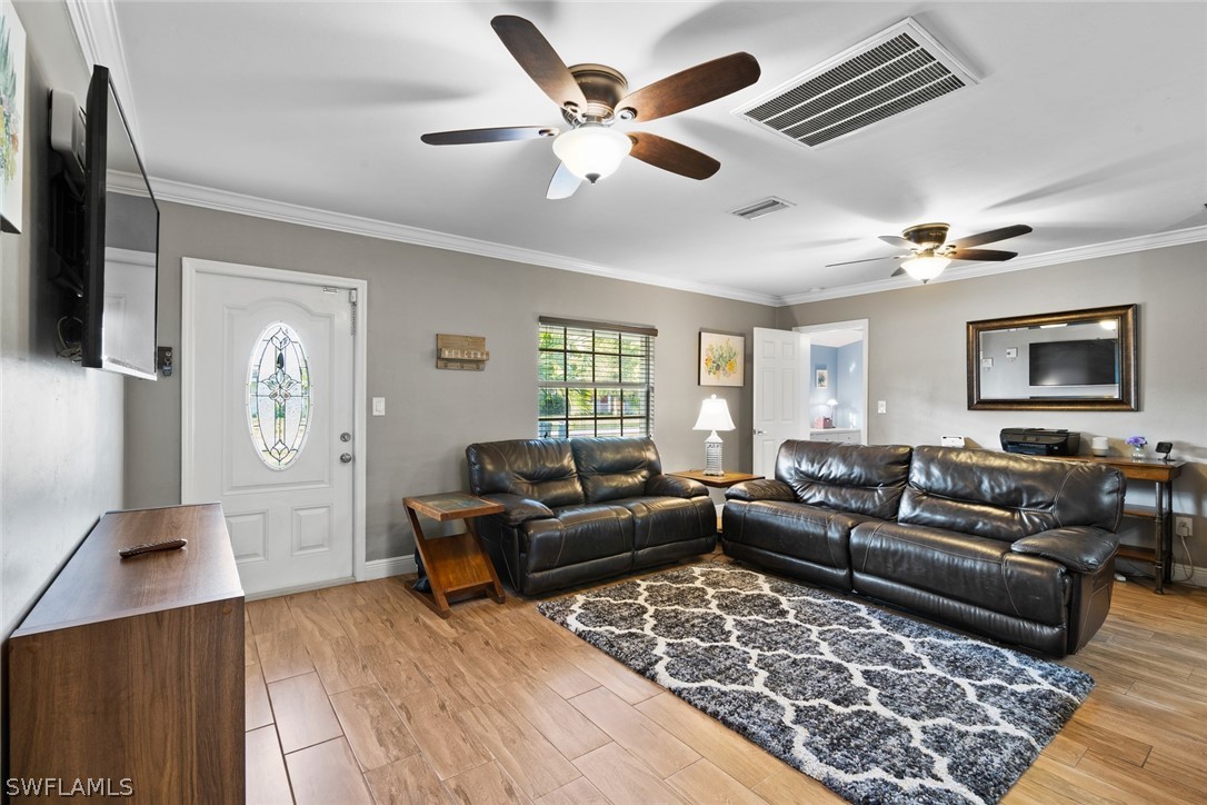 1447 Collins Road Fort Myers, FL 33919 - Photo 8 of 34 a living room with furniture and a flat screen tv