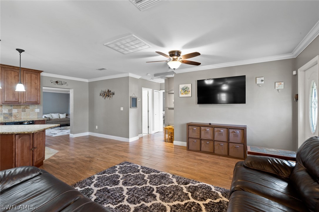 1447 Collins Road Fort Myers, FL 33919 - Photo 9 of 34 a living room with stainless steel appliances furniture and a flat screen tv
