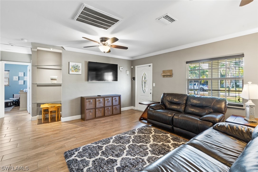 1447 Collins Road Fort Myers, FL 33919 - Photo 10 of 34 a living room with furniture and a flat screen tv