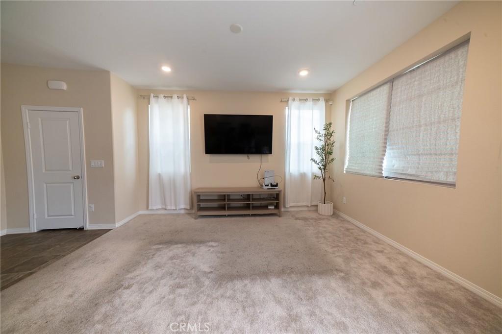 2464 Gunner Ridge Way Rialto, CA 92377 - Photo 11 of 42 a view of livingroom with workspace and a flat screen tv