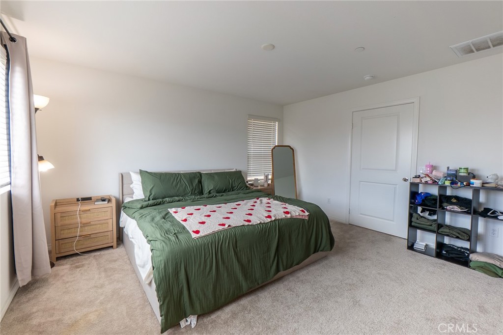 2464 Gunner Ridge Way Rialto, CA 92377 - Photo 12 of 42 a bedroom with a bed and a table