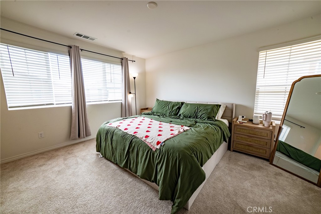 2464 Gunner Ridge Way Rialto, CA 92377 - Photo 13 of 42 a bedroom with a bed and a chair