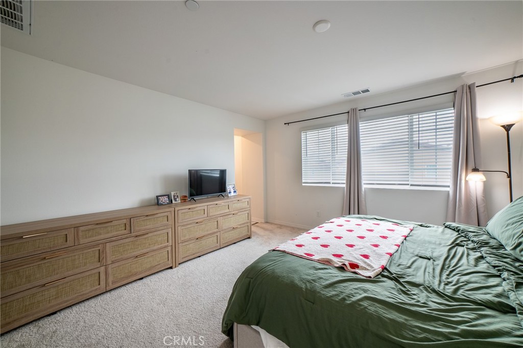 2464 Gunner Ridge Way Rialto, CA 92377 - Photo 14 of 42 a bedroom with a bed and a flat screen tv