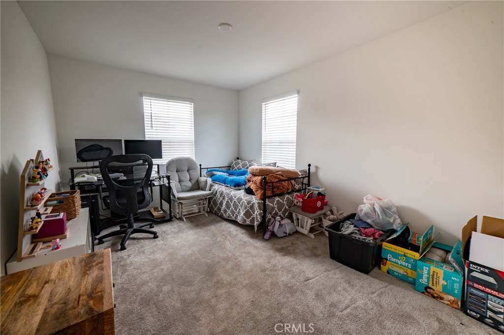 2464 Gunner Ridge Way Rialto, CA 92377 - Photo 17 of 42 a room with furniture and a window