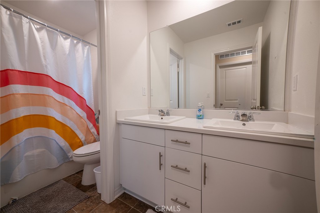2464 Gunner Ridge Way Rialto, CA 92377 - Photo 18 of 42 a bathroom with a sink and a mirror