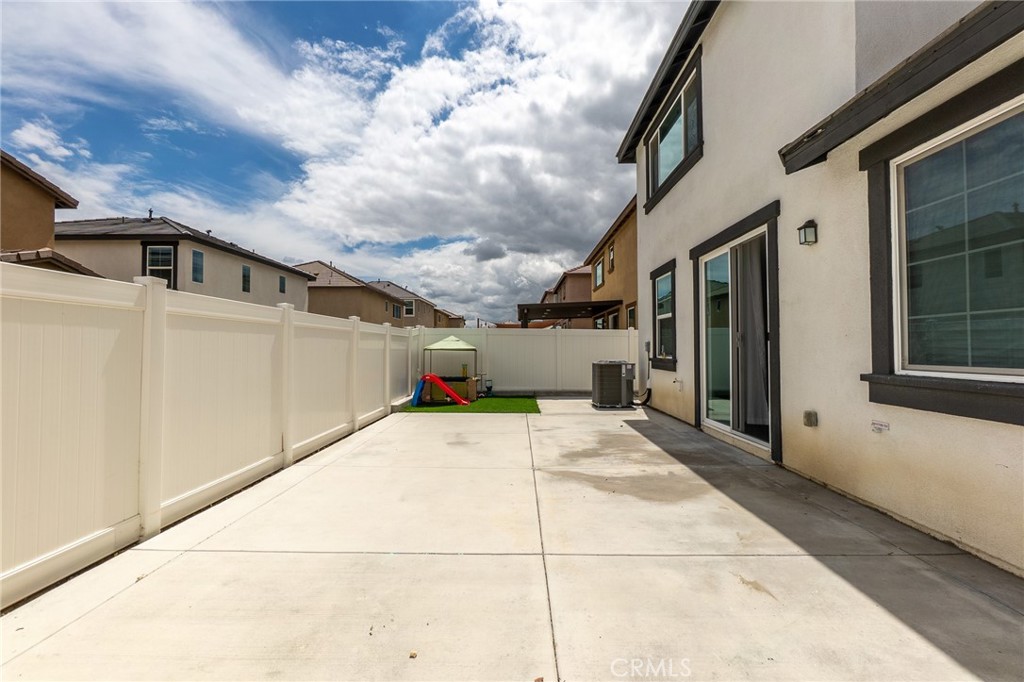 2464 Gunner Ridge Way Rialto, CA 92377 - Photo 5 of 42 a view of a parking space with wooden fence
