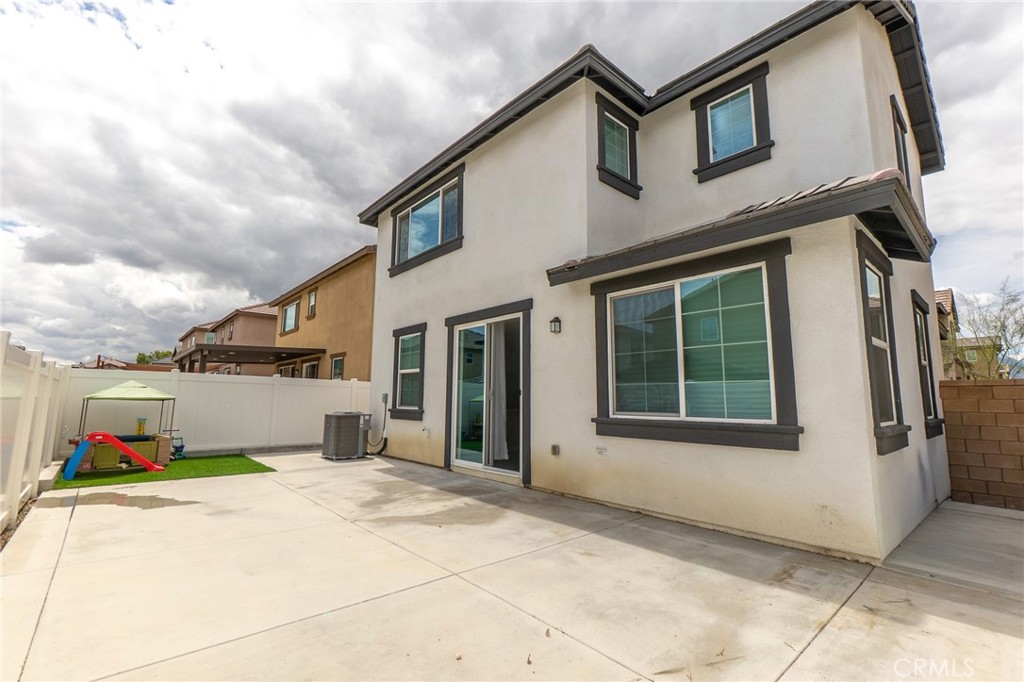 2464 Gunner Ridge Way Rialto, CA 92377 - Photo 6 of 42 a front view of a house with a yard and garage