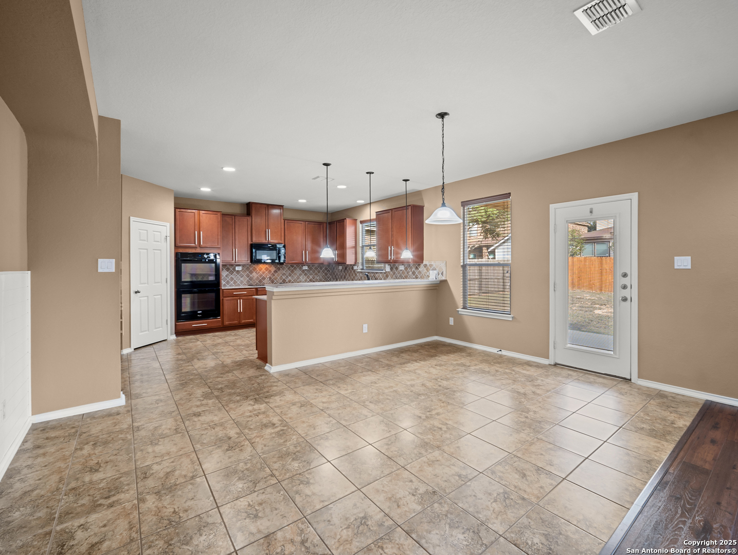 7514 Copper Cove Converse, TX 78109 - Photo 11 of 33 a kitchen with stainless steel appliances granite countertop a refrigerator and a stove top oven