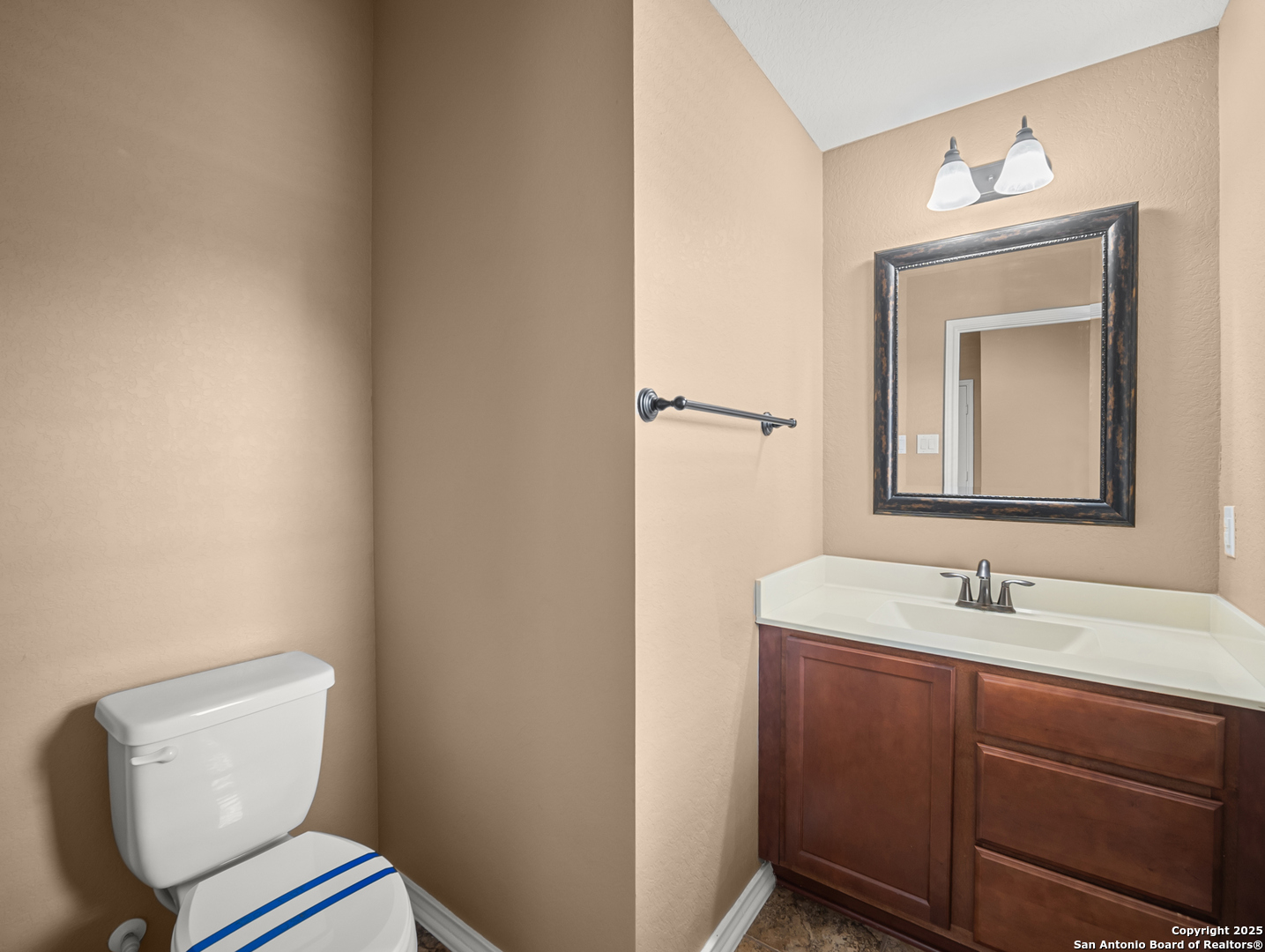 7514 Copper Cove Converse, TX 78109 - Photo 6 of 33 a bathroom with a toilet sink and mirror