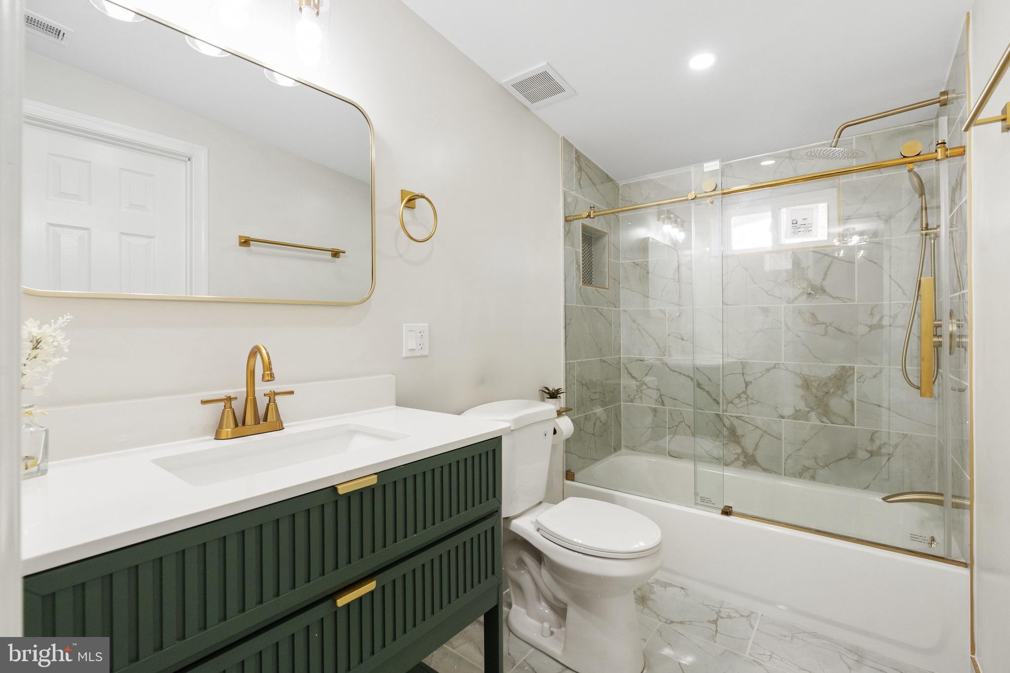 1203 Moore Street Philadelphia, PA 19148 - Photo 15 of 41 a bathroom with a sink a toilet and shower