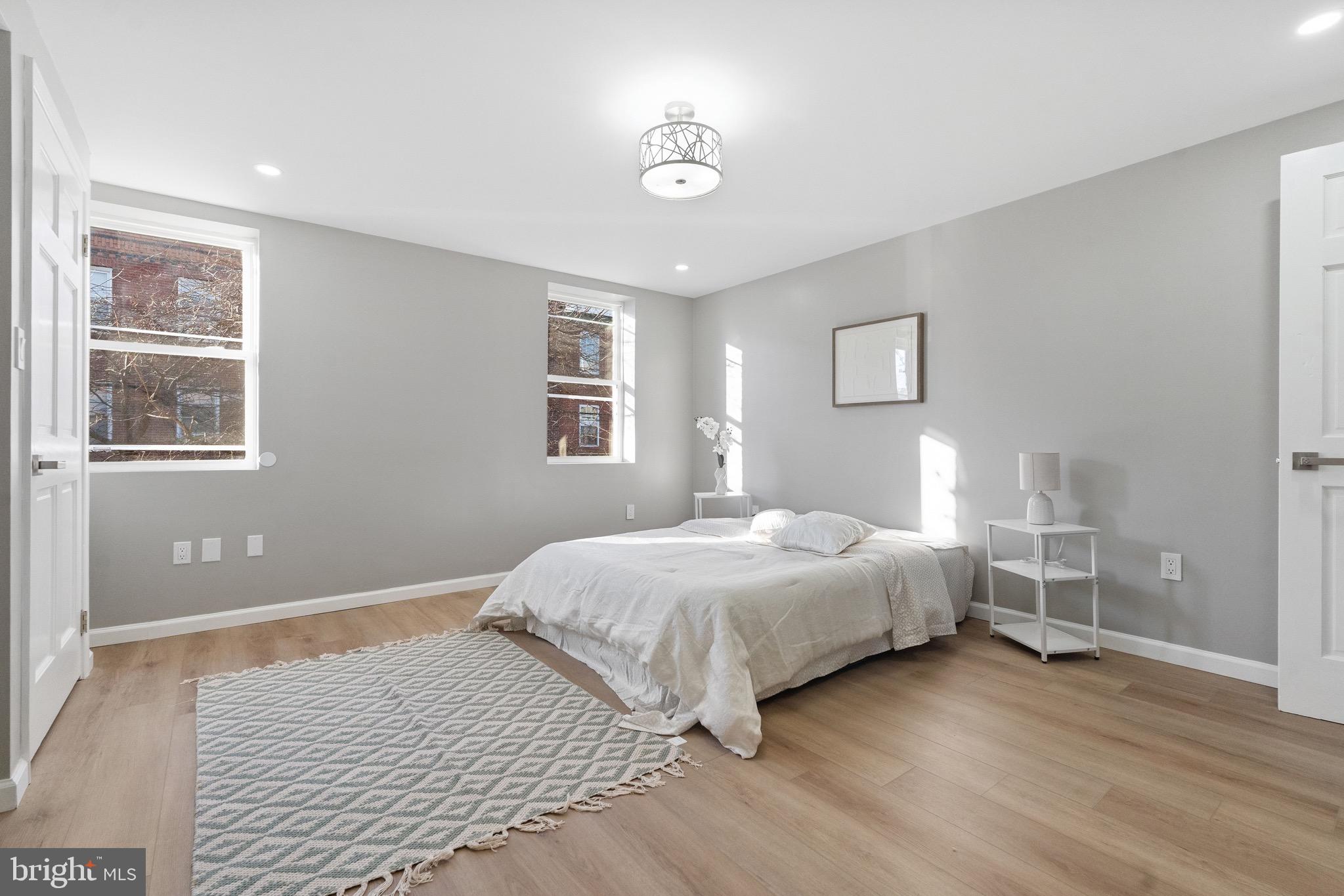 1203 Moore Street Philadelphia, PA 19148 - Photo 17 of 41 a bedroom with a bed and wooden floor