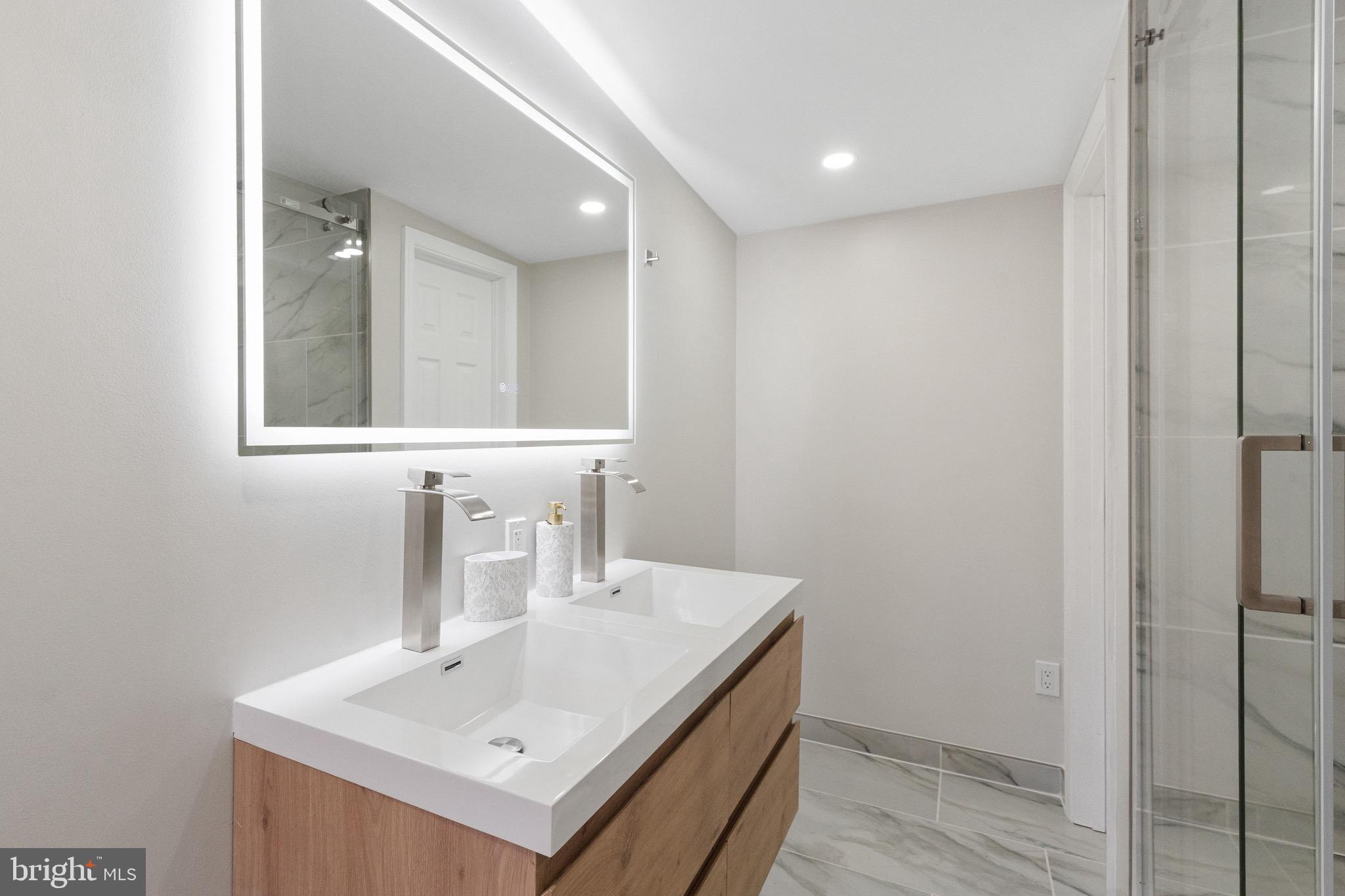 1203 Moore Street Philadelphia, PA 19148 - Photo 19 of 41 a bathroom with a sink and a mirror