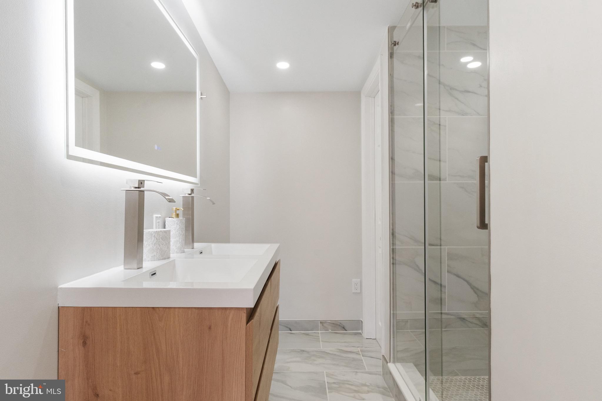 1203 Moore Street Philadelphia, PA 19148 - Photo 20 of 41 a bathroom with a sink a mirror and a shower