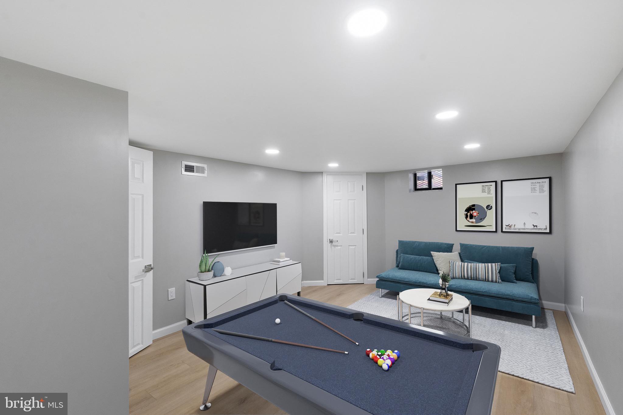 1203 Moore Street Philadelphia, PA 19148 - Photo 22 of 41 a living room with furniture and a flat screen tv