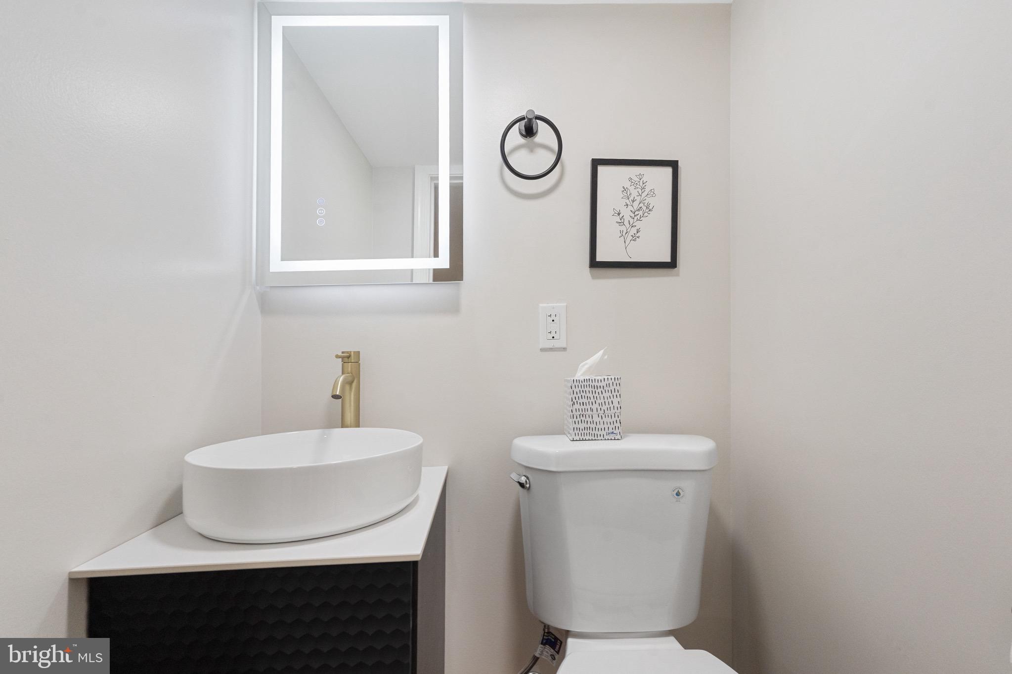 1203 Moore Street Philadelphia, PA 19148 - Photo 25 of 41 a bathroom with a sink a toilet and a mirror