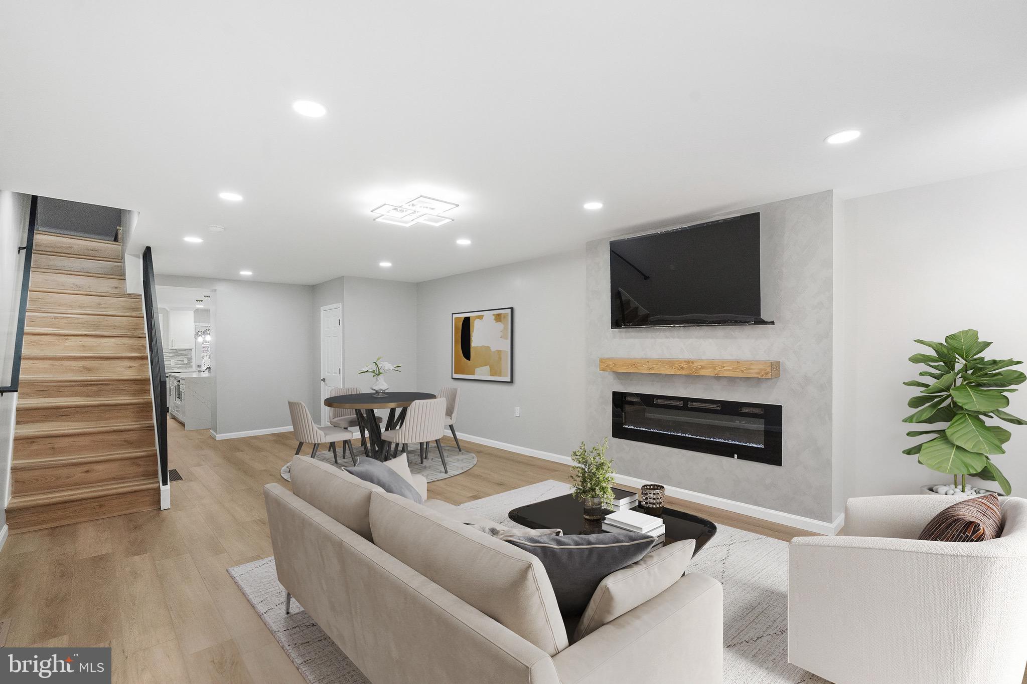 1203 Moore Street Philadelphia, PA 19148 - Photo 3 of 41 a living room with furniture a fireplace and a flat screen tv