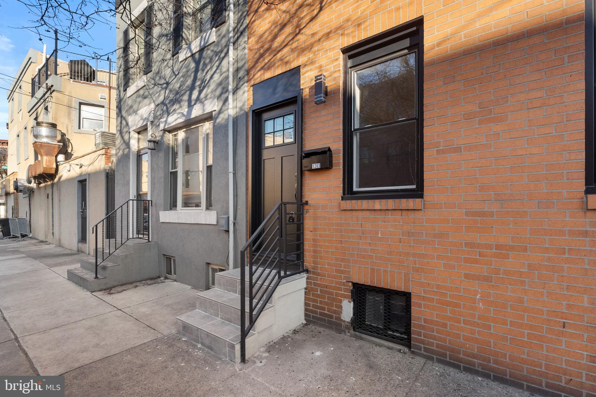 1203 Moore Street Philadelphia, PA 19148 - Photo 36 of 41 a view of a brick house with many windows