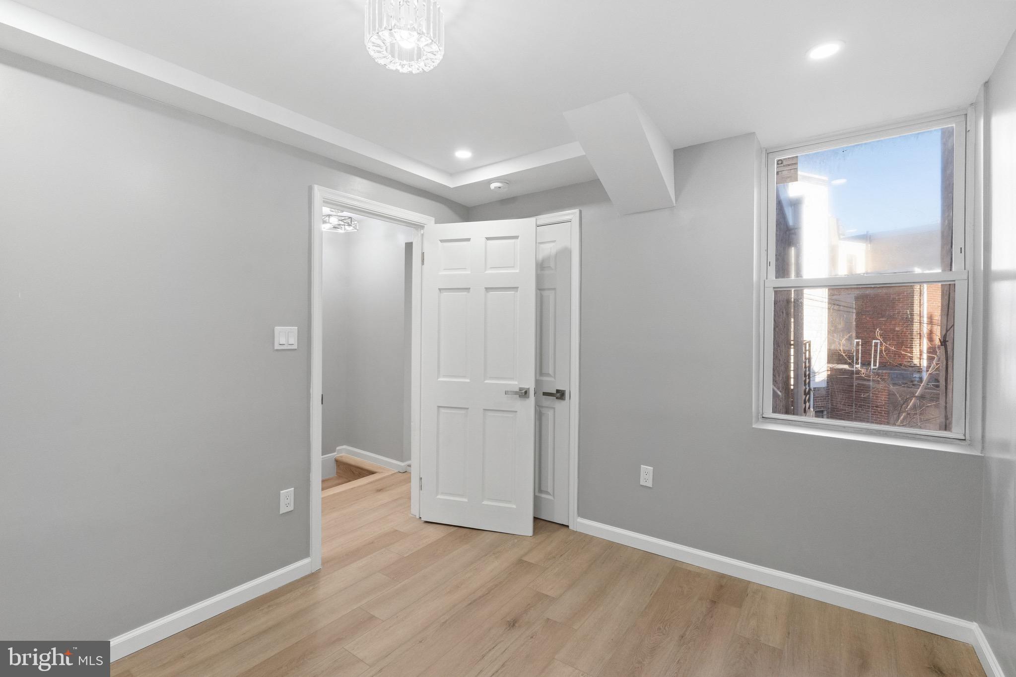 1203 Moore Street Philadelphia, PA 19148 - Photo 38 of 41 a view of an empty room with wooden floor and a window