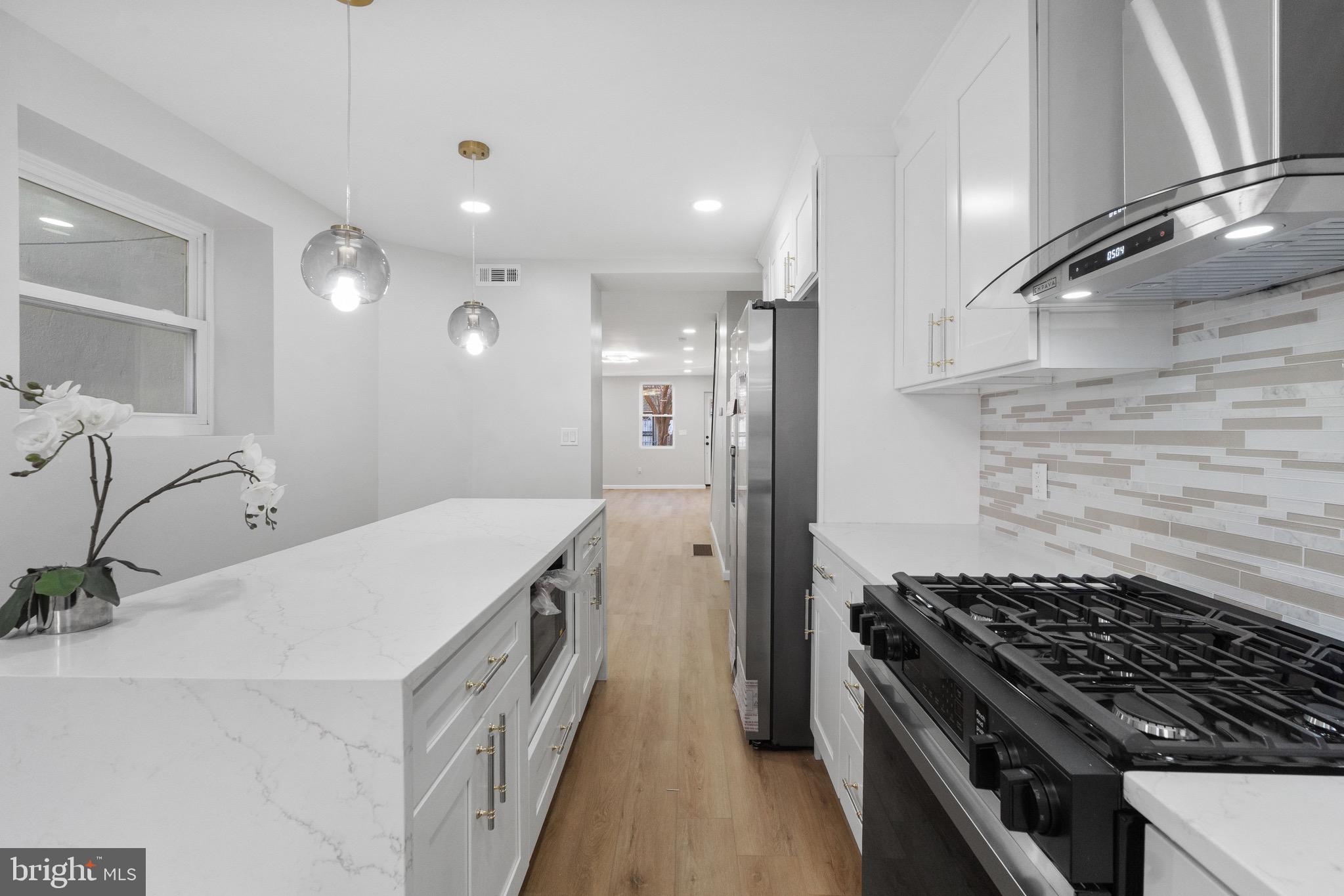1203 Moore Street Philadelphia, PA 19148 - Photo 8 of 41 a kitchen with a stove and a refrigerator