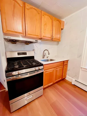 a stove top oven sitting inside of a kitchen