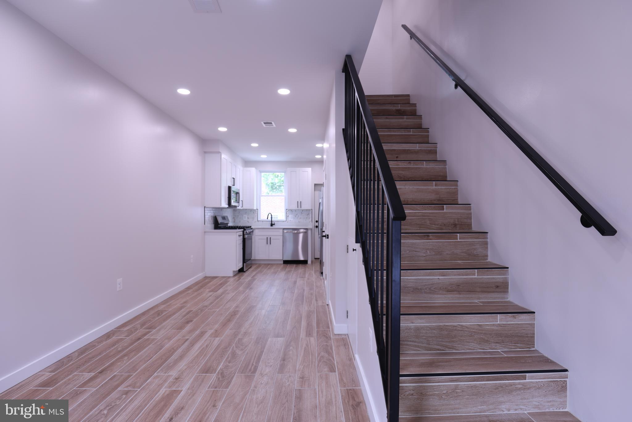 2039 Rosedale Street Northeast Washington, DC 20002 - Photo 2 of 18 a view of a hallway with wooden floor and staircase