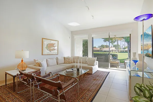 a living room with furniture and a floor to ceiling window