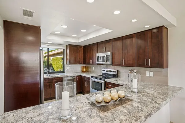 a kitchen with a sink cabinets and window