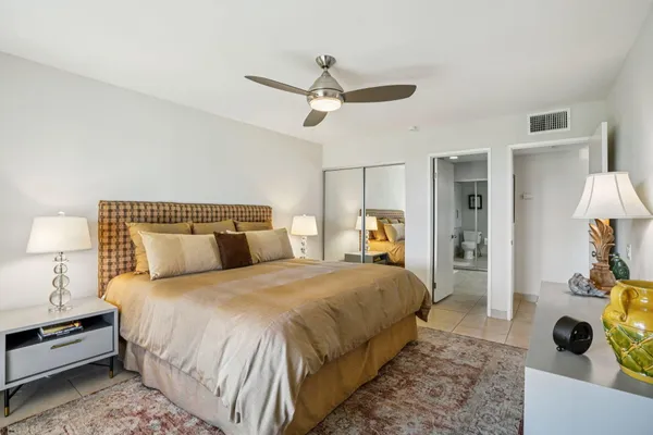 a bedroom with a bed and a lamp