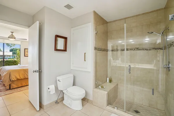 a bathroom with a toilet and a shower