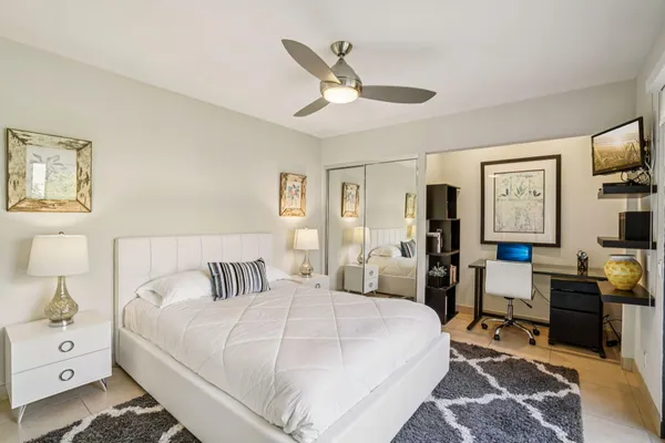 a bedroom with a bed and a desk