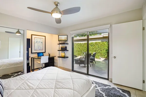 a bedroom with a large bed and a window