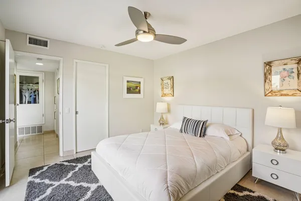 a bedroom with a bed and a lamp