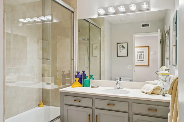 a bathroom with a sink double vanity and shower