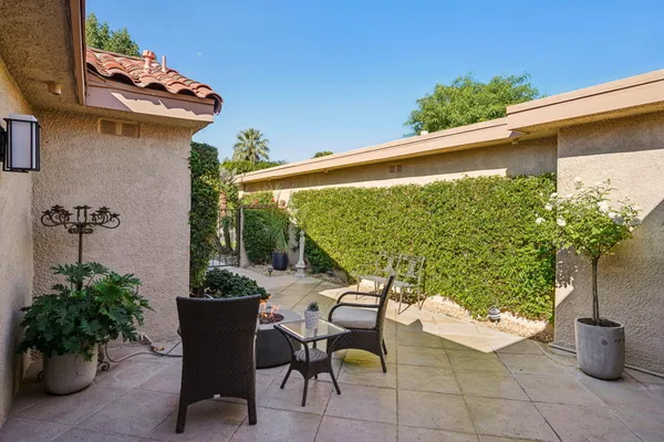 a view of a chairs and table in patio