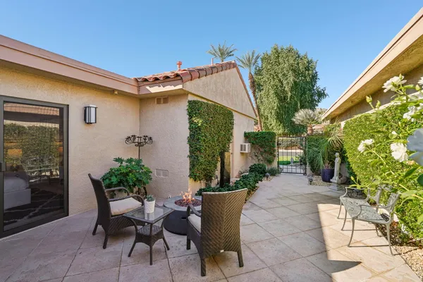 a view of a house with backyard sitting area and garden