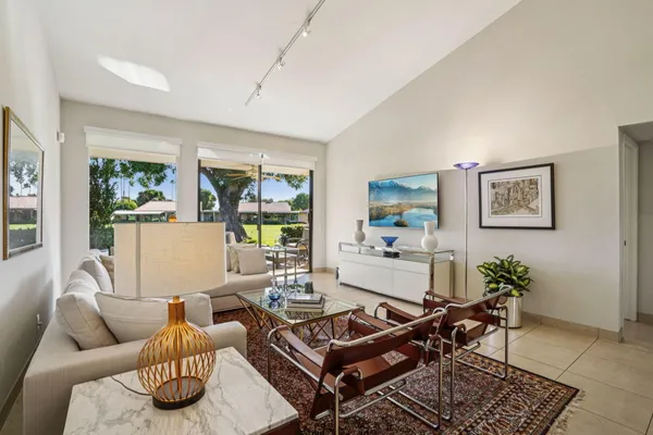 a living room with furniture and a potted plant