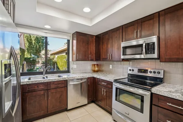 a kitchen with a sink stove and microwave
