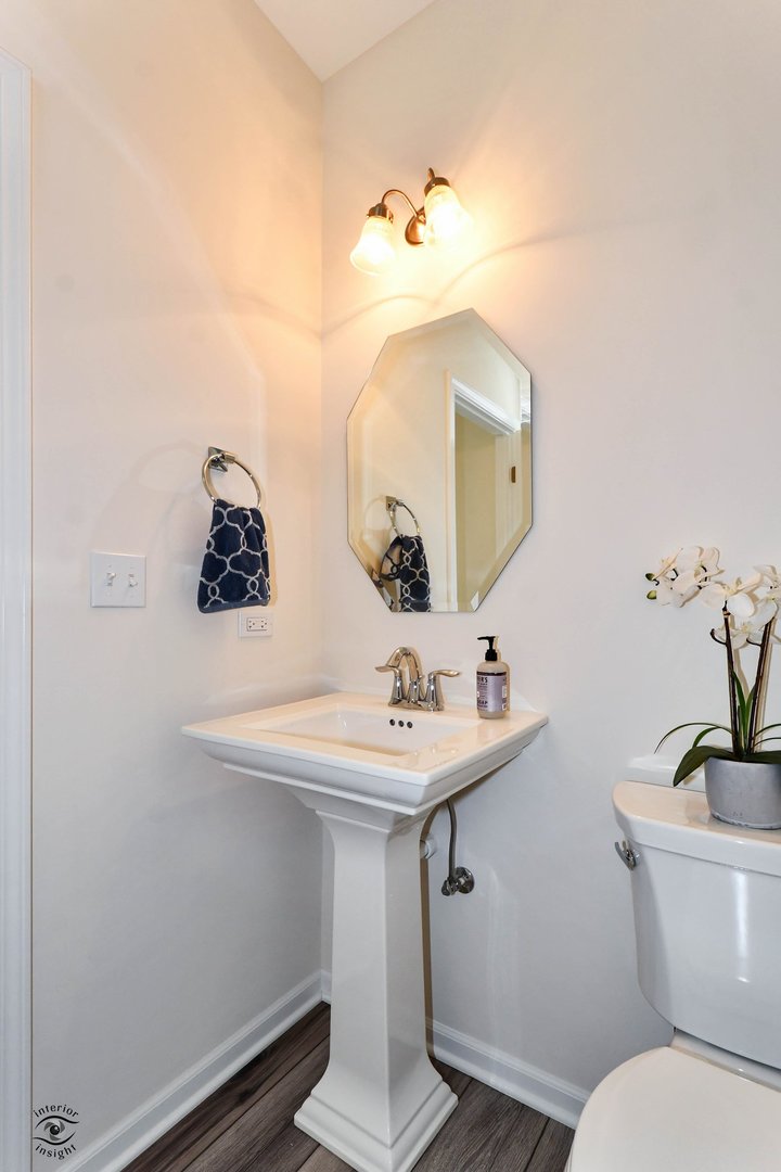 4154 Irving Road Aurora, IL 60504 - Photo 13 of 25 a bathroom with a toilet sink and mirror