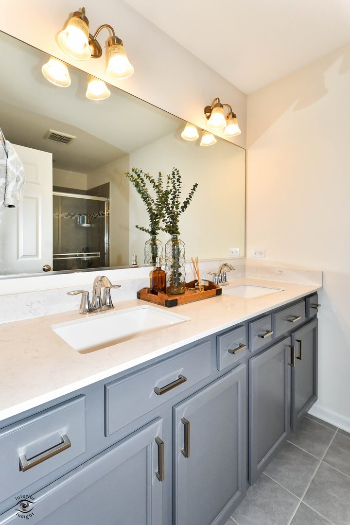 4154 Irving Road Aurora, IL 60504 - Photo 17 of 25 a bathroom with a sink vanity and a mirror