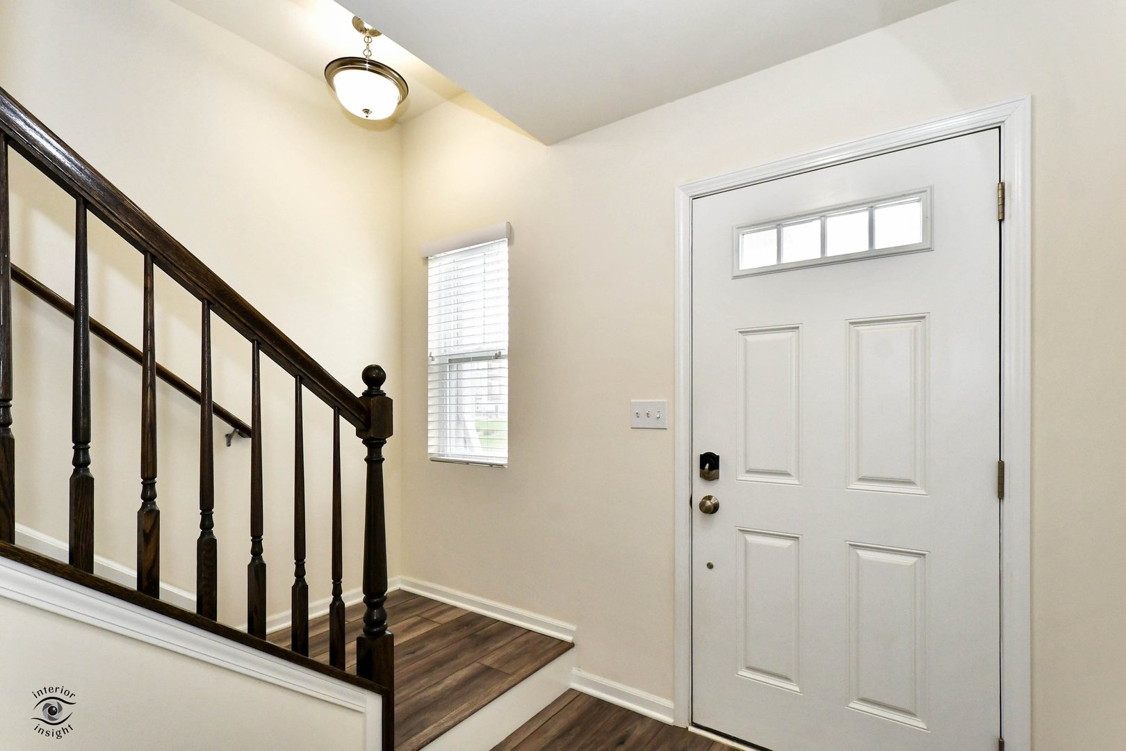 4154 Irving Road Aurora, IL 60504 - Photo 3 of 25 a view of a hallway with wooden floor and staircase