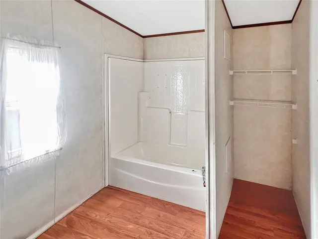 a bathroom with a bathtub and a shower