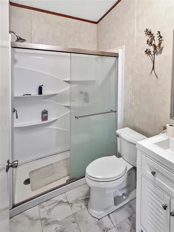 a bathroom with a toilet and a shower