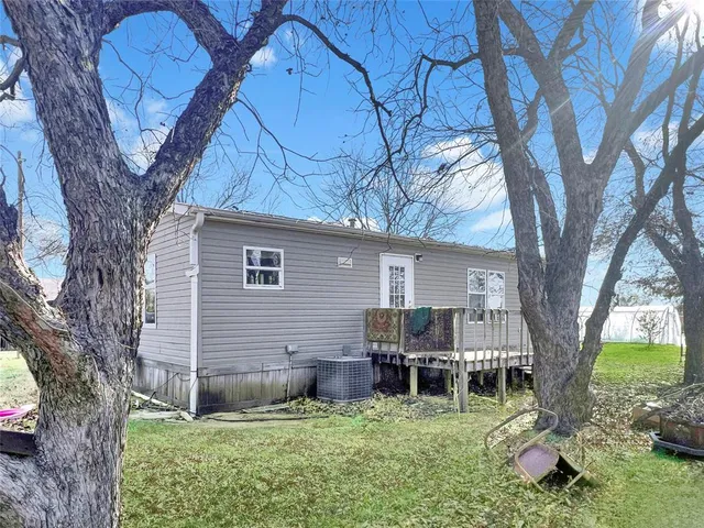 a backyard of a house with table and chairs