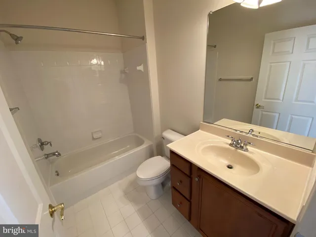 a bathroom with a sink mirror toilet and bathtub