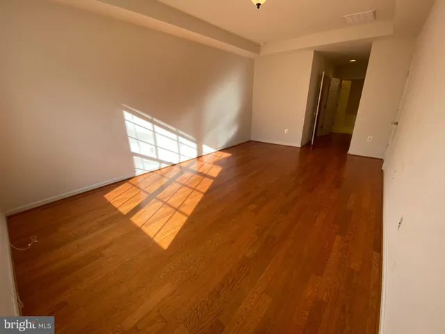 a view of an empty room and wooden floor