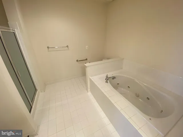 a bathroom with a bathtub and shower