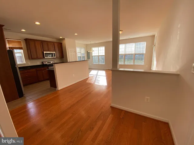 a view of kitchen with cabinets and wooden floor