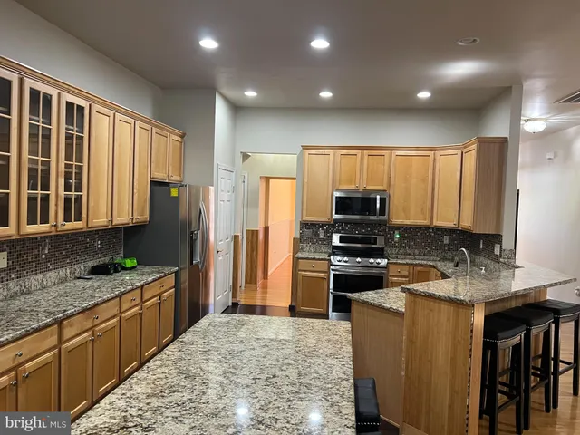 a kitchen with refrigerator cabinets and furniture